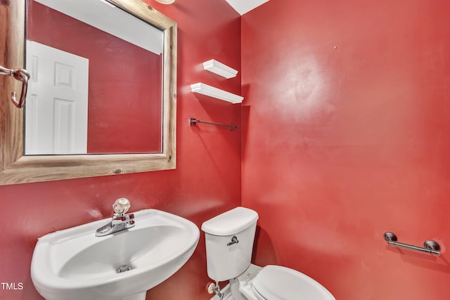 half bath with a sink and toilet