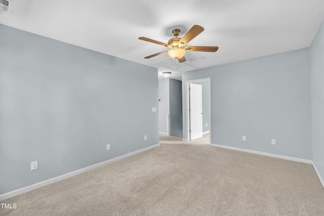 empty room with ceiling fan, light colored carpet, and baseboards