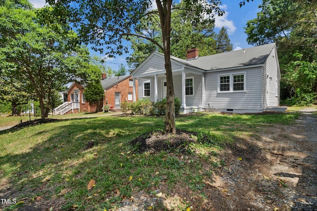 bungalow featuring a chimney, a porch, a front lawn, and crawl space