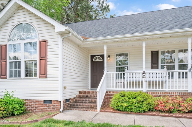 view of exterior entry with crawl space, covered porch, and a shingled roof