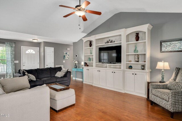 living area featuring lofted ceiling, a ceiling fan, and light wood-style flooring