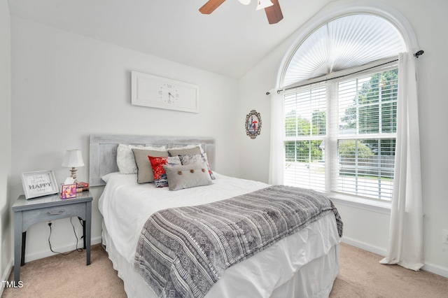 bedroom with carpet flooring, multiple windows, baseboards, and vaulted ceiling