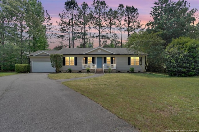 635 Chuckar Ct, Vass, NC 28394 - ranch-style home with a porch, aphalt driveway, an attached garage, crawl space, and a lawn