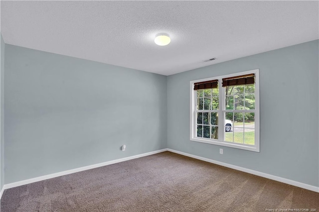 635 Chuckar Ct, Vass, NC 28394 - unfurnished room with a textured ceiling, visible vents, baseboards, and dark carpet