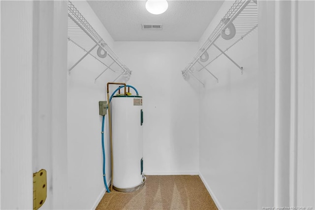 635 Chuckar Ct, Vass, NC 28394 - walk in closet featuring water heater, visible vents, and carpet floors