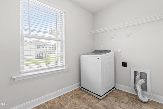 washroom with washer / dryer, baseboards, and stone finish flooring