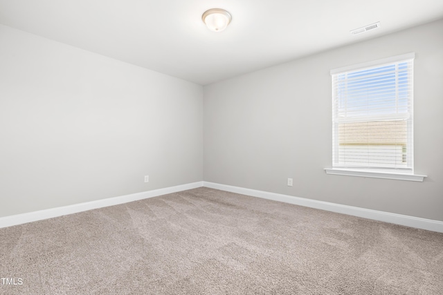 spare room with carpet floors and baseboards