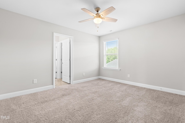 empty room with light carpet, baseboards, and ceiling fan