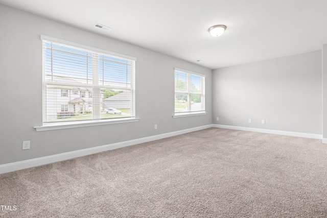 carpeted spare room with baseboards