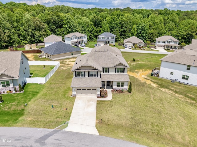 aerial perspective of suburban area featuring a heavily wooded area