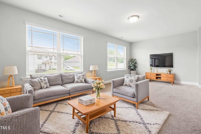 living area with baseboards and carpet flooring