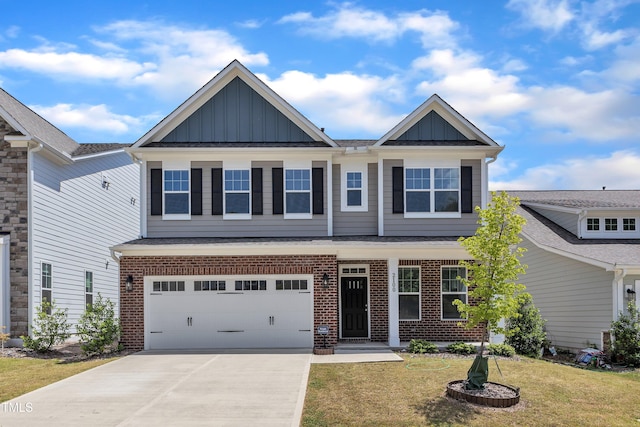 2100 Curry Meadow Way, Durham, NC 27703 - view of front of home featuring board and batten siding, brick siding, concrete driveway, and a garage