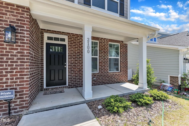 2100 Curry Meadow Way, Durham, NC 27703 - view of exterior entry featuring a porch and brick siding