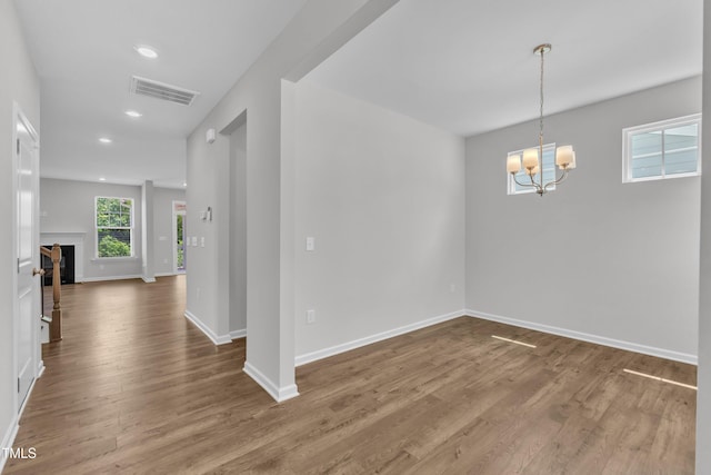 2100 Curry Meadow Way, Durham, NC 27703 - empty room featuring wood finished floors, a chandelier, baseboards, and recessed lighting
