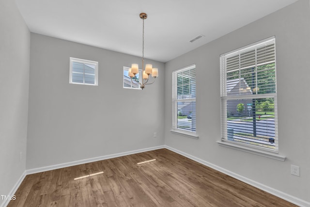 2100 Curry Meadow Way, Durham, NC 27703 - empty room featuring a chandelier, wood finished floors, and baseboards