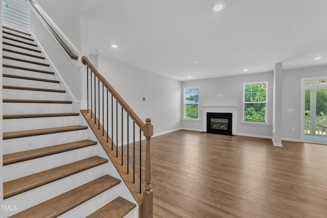 2100 Curry Meadow Way, Durham, NC 27703 - unfurnished living room featuring recessed lighting, healthy amount of natural light, wood finished floors, stairway, and baseboards