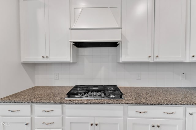 2100 Curry Meadow Way, Durham, NC 27703 - kitchen with stainless steel gas stovetop, custom range hood, white cabinetry, and backsplash