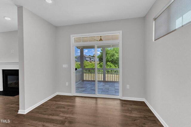 2100 Curry Meadow Way, Durham, NC 27703 - spare room featuring dark wood-style floors, baseboards, a fireplace with flush hearth, and recessed lighting