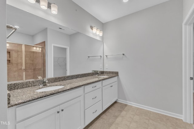 2100 Curry Meadow Way, Durham, NC 27703 - full bath featuring double vanity, a shower stall, a spacious closet, and baseboards
