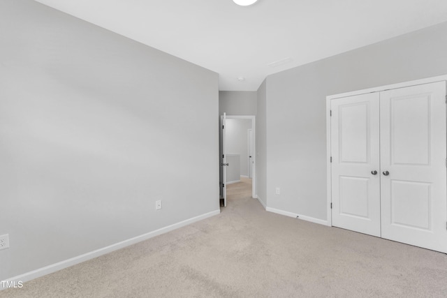 2100 Curry Meadow Way, Durham, NC 27703 - unfurnished bedroom with baseboards, carpet floors, and a closet