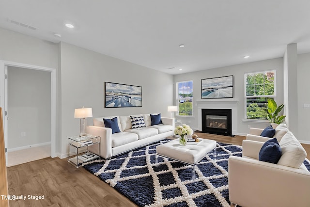 2100 Curry Meadow Way, Durham, NC 27703 - living room with wood finished floors, a glass covered fireplace, healthy amount of natural light, and recessed lighting