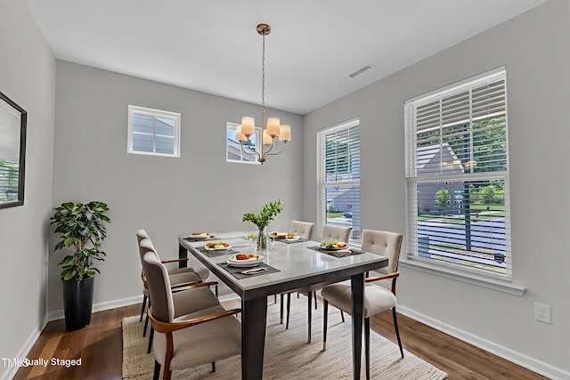 2100 Curry Meadow Way, Durham, NC 27703 - dining space featuring a chandelier, dark wood-style floors, and baseboards
