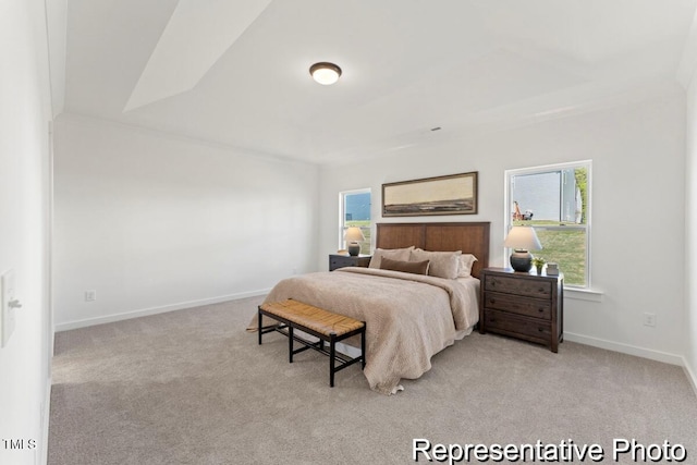 bedroom featuring light carpet and baseboards