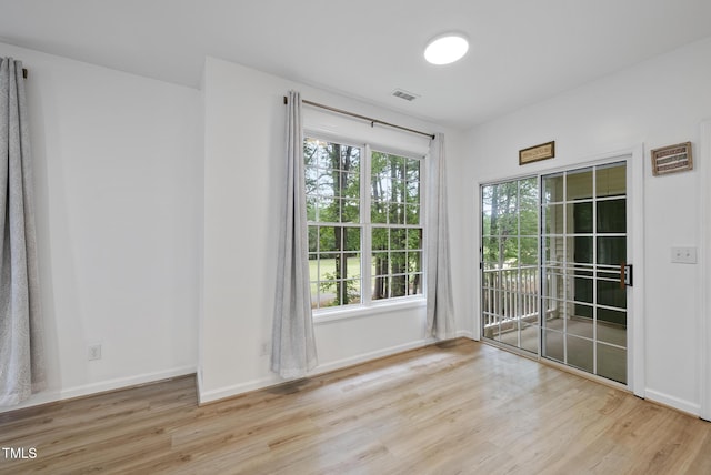 unfurnished room featuring wood finished floors and baseboards