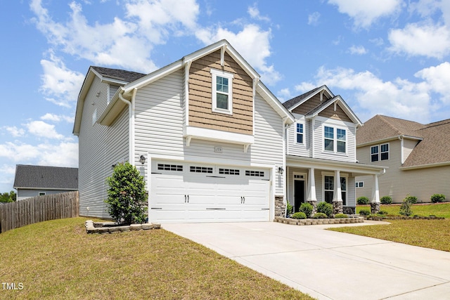 craftsman inspired home featuring a porch, fence, driveway, a garage, and a front lawn