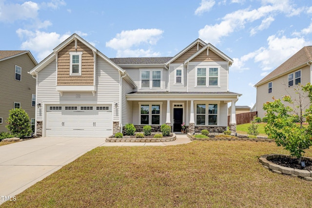 craftsman inspired home featuring a porch, an attached garage, stone siding, driveway, and a front yard