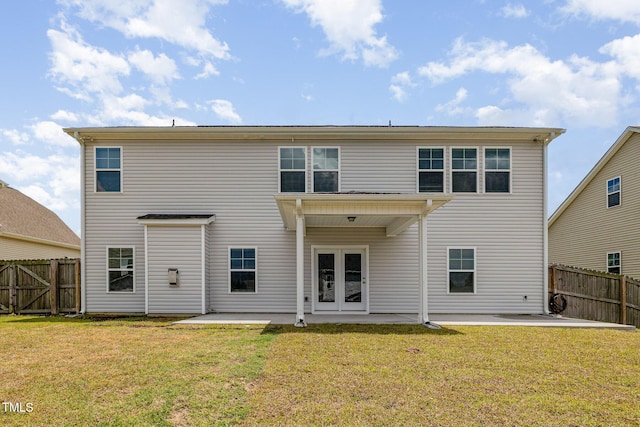 rear view of house featuring a yard, a patio, and fence