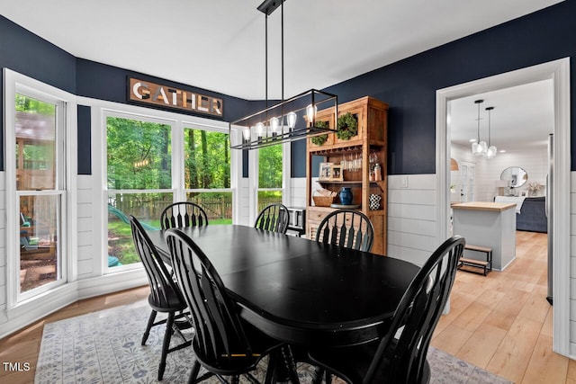 dining area featuring a chandelier and light wood-style floors