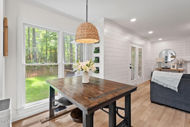 dining area featuring healthy amount of natural light, light wood-type flooring, ornamental molding, french doors, and recessed lighting