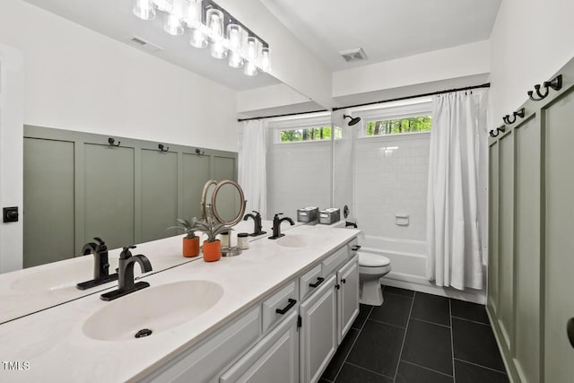 full bath with tile patterned flooring, shower / tub combo, double vanity, and toilet