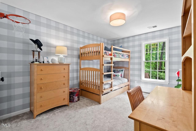 bedroom with wallpapered walls and carpet flooring