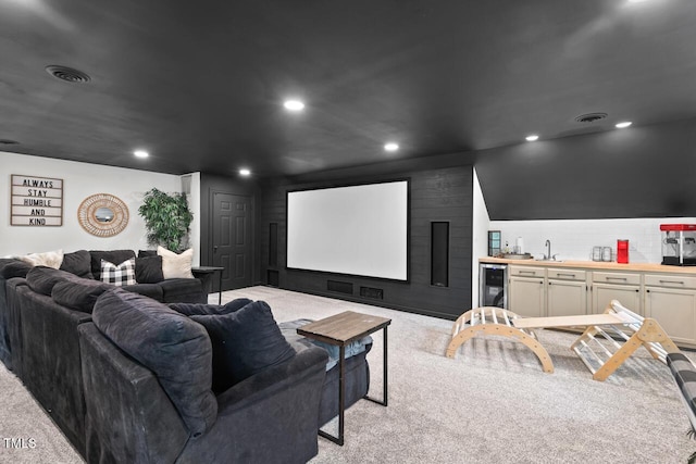 home theater room featuring light carpet, wine cooler, recessed lighting, and bar