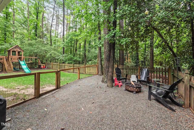 view of yard with a fire pit and a playground