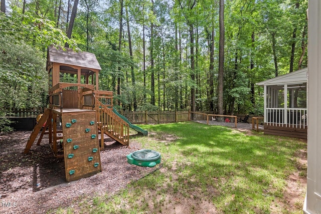 view of yard with a sunroom and a playground