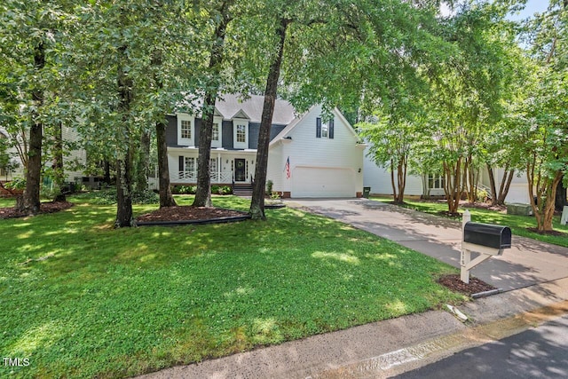 view of front facade with driveway, a garage, and a front lawn