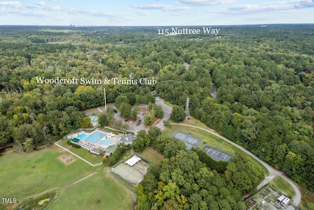aerial view of property's location with a heavily wooded area