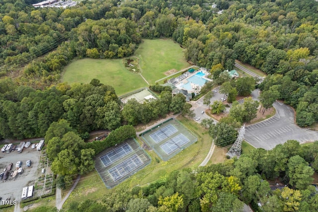 view of property location with a forest