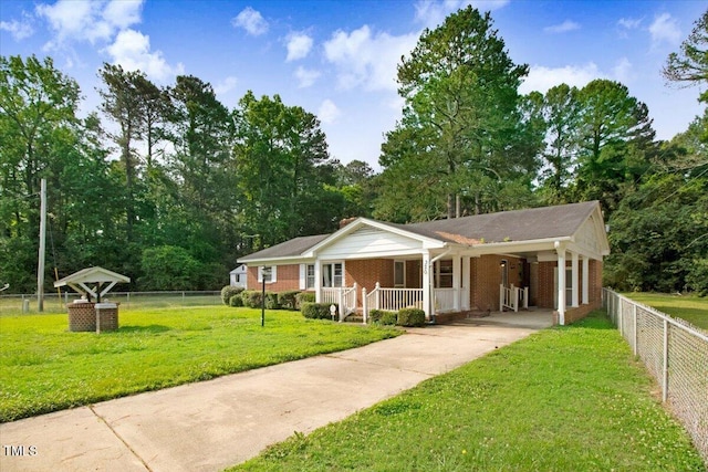 320 Dead End Rd, Enfield, NC 27823 - single story home featuring a porch, brick siding, concrete driveway, and a carport