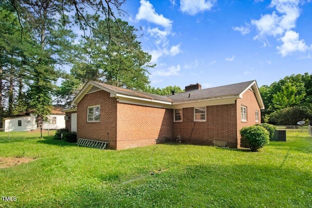 320 Dead End Rd, Enfield, NC 27823 - view of side of property with brick siding, a yard, and a chimney