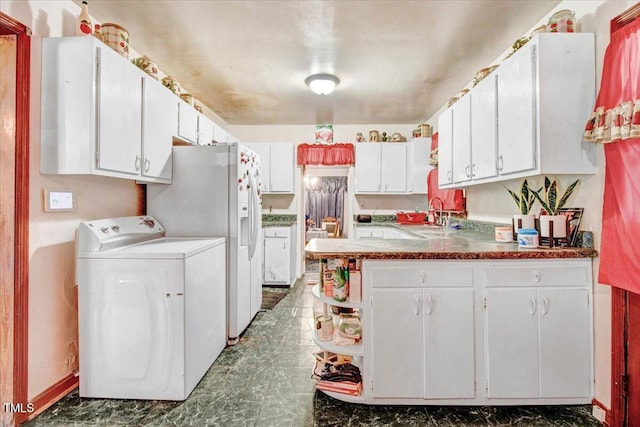 320 Dead End Rd, Enfield, NC 27823 - kitchen with washer / clothes dryer, a peninsula, white cabinets, white refrigerator with ice dispenser, and open shelves