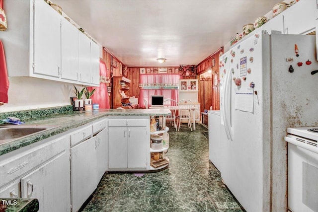 320 Dead End Rd, Enfield, NC 27823 - kitchen with white appliances, white cabinets, a peninsula, light countertops, and dark floors