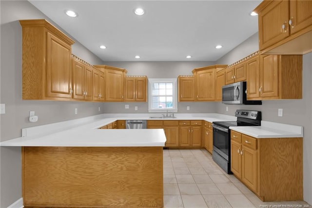 kitchen featuring a peninsula, stainless steel appliances, light countertops, light tile patterned flooring, and recessed lighting