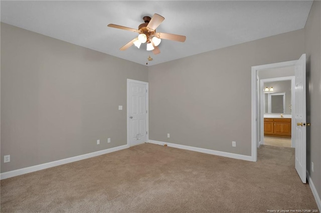 unfurnished bedroom with light carpet, baseboards, and a ceiling fan