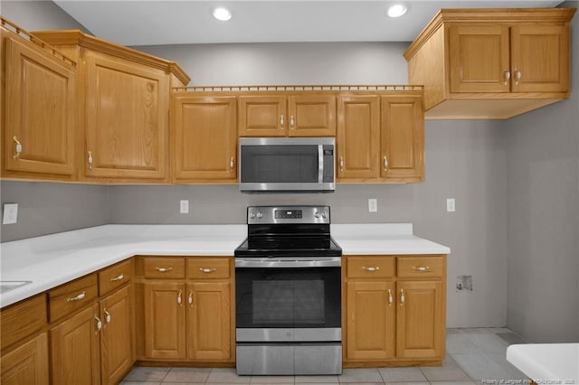kitchen featuring light countertops, appliances with stainless steel finishes, light tile patterned floors, and recessed lighting