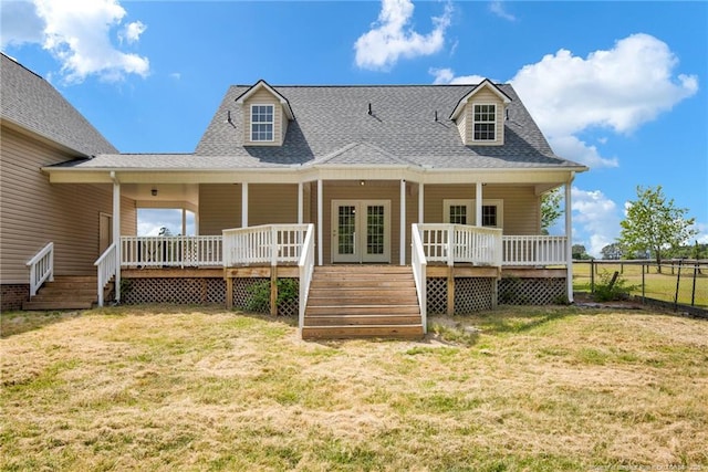 back of property featuring roof with shingles, fence, french doors, and a lawn