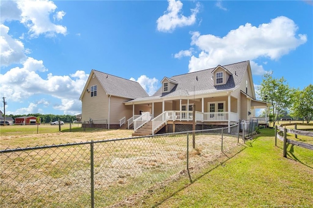 back of house with a lawn, roof with shingles, and a fenced backyard